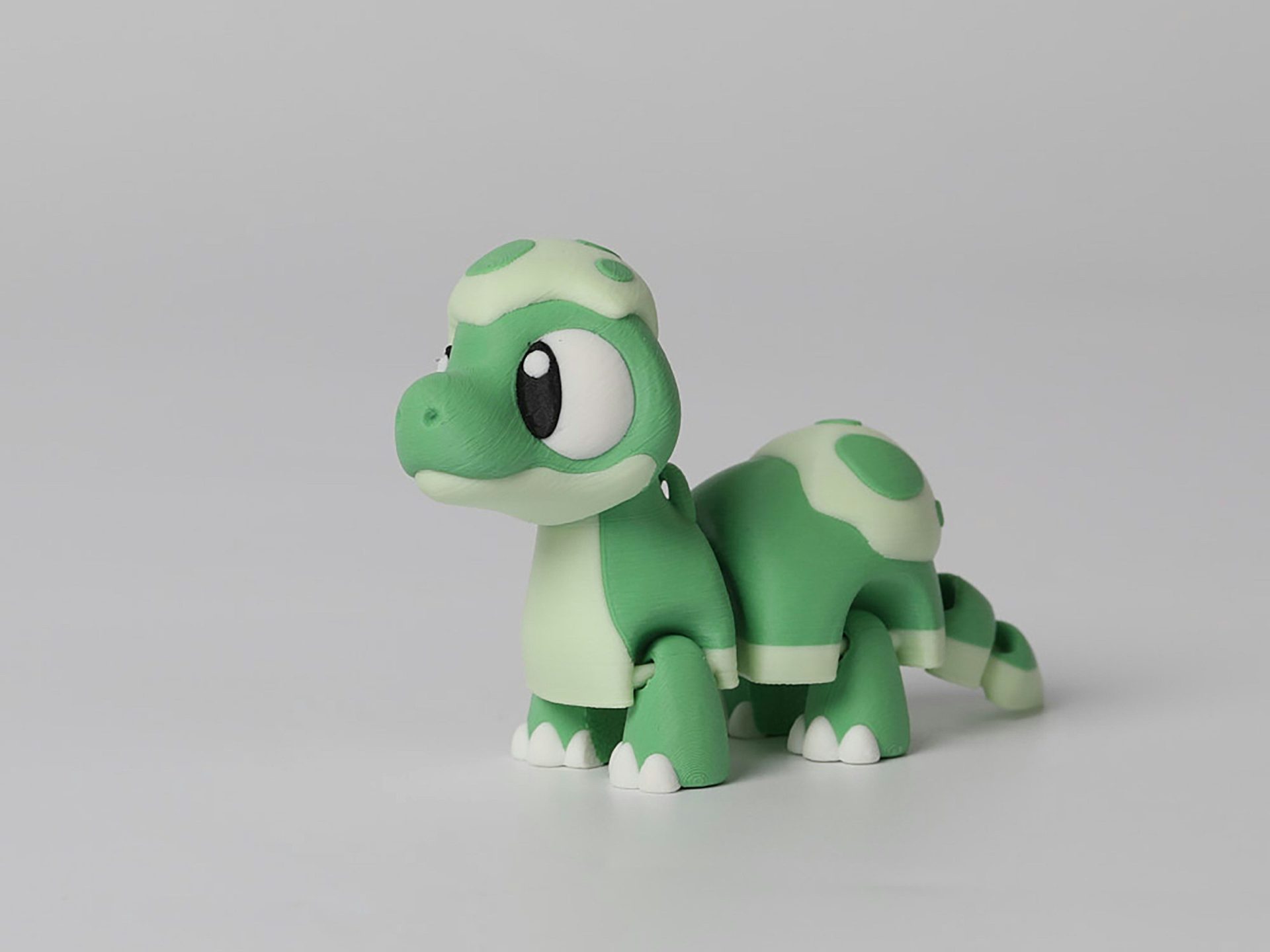 A cute green cartoon turtle toy on a white background